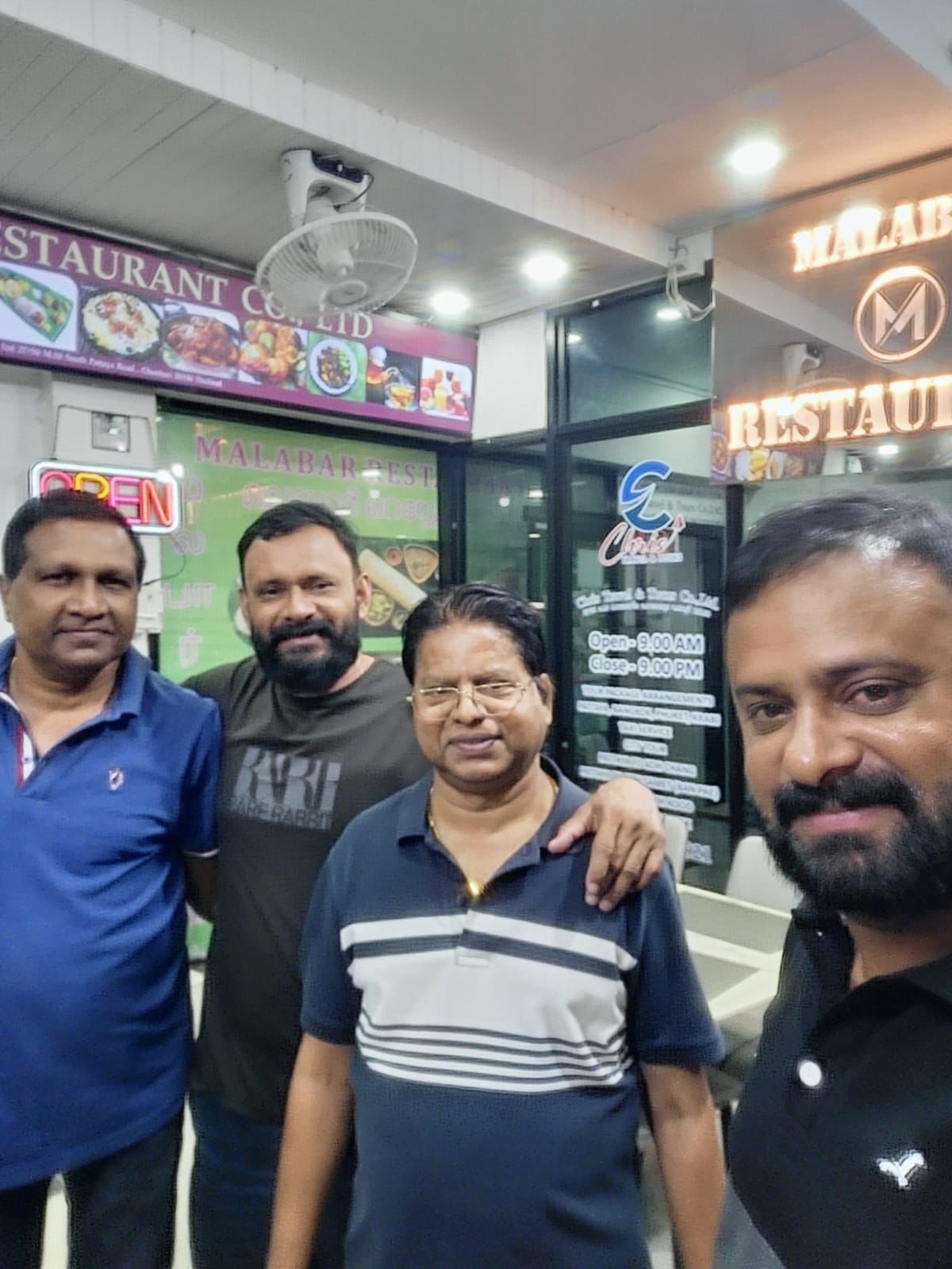 Men Posing Outside Entrance Night